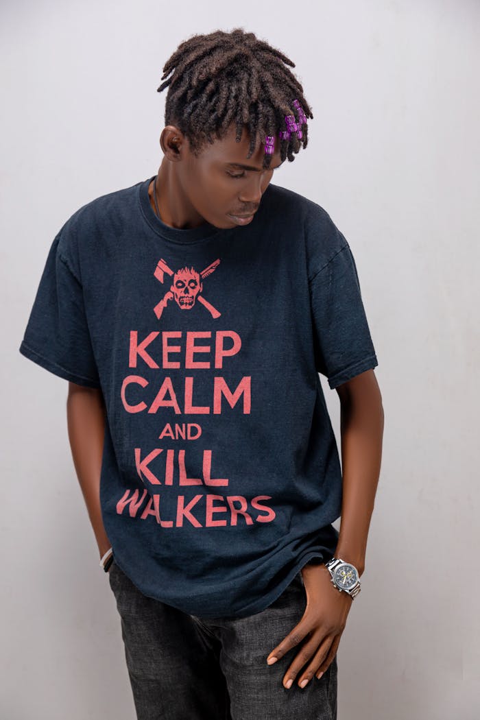 Young man posing in a graphic T-shirt with 'Keep Calm and Kill Walkers' print.